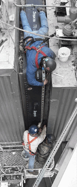 Two men installing an expansion joint.